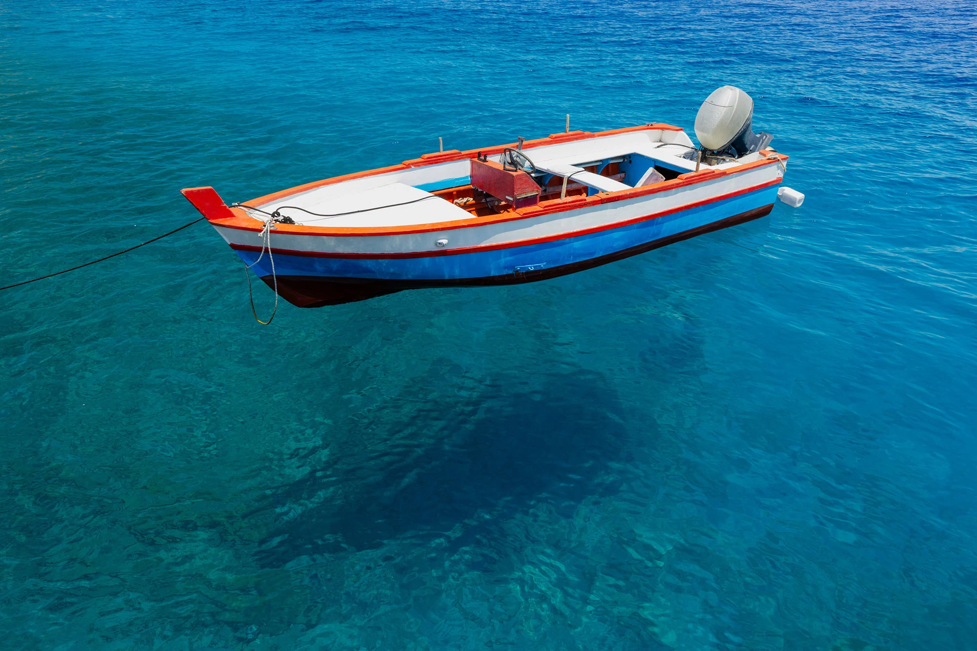 A small wooden fishing boat on the water in the Aeolian Islands, Sicily.