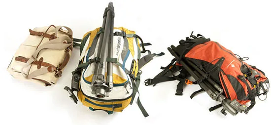 Three camera-and-tripod backpacks side by side — a canvas pack, a yellow Patagonia, and an orange Black Diamond, each rigged to carry a tripod