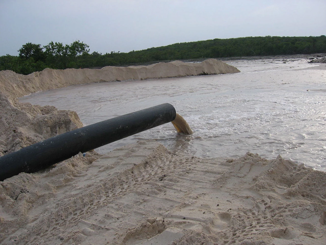 A pipe pumping saltwater directly into the porous limestone at the center of the Baker's Bay property, the same kind of pumping error the EMT's February 2008 report found had flooded a mangrove wetland and damaged its hydrology.