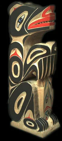 A carved and painted Makah bear rattle with stylized black, red and blue formline designs.