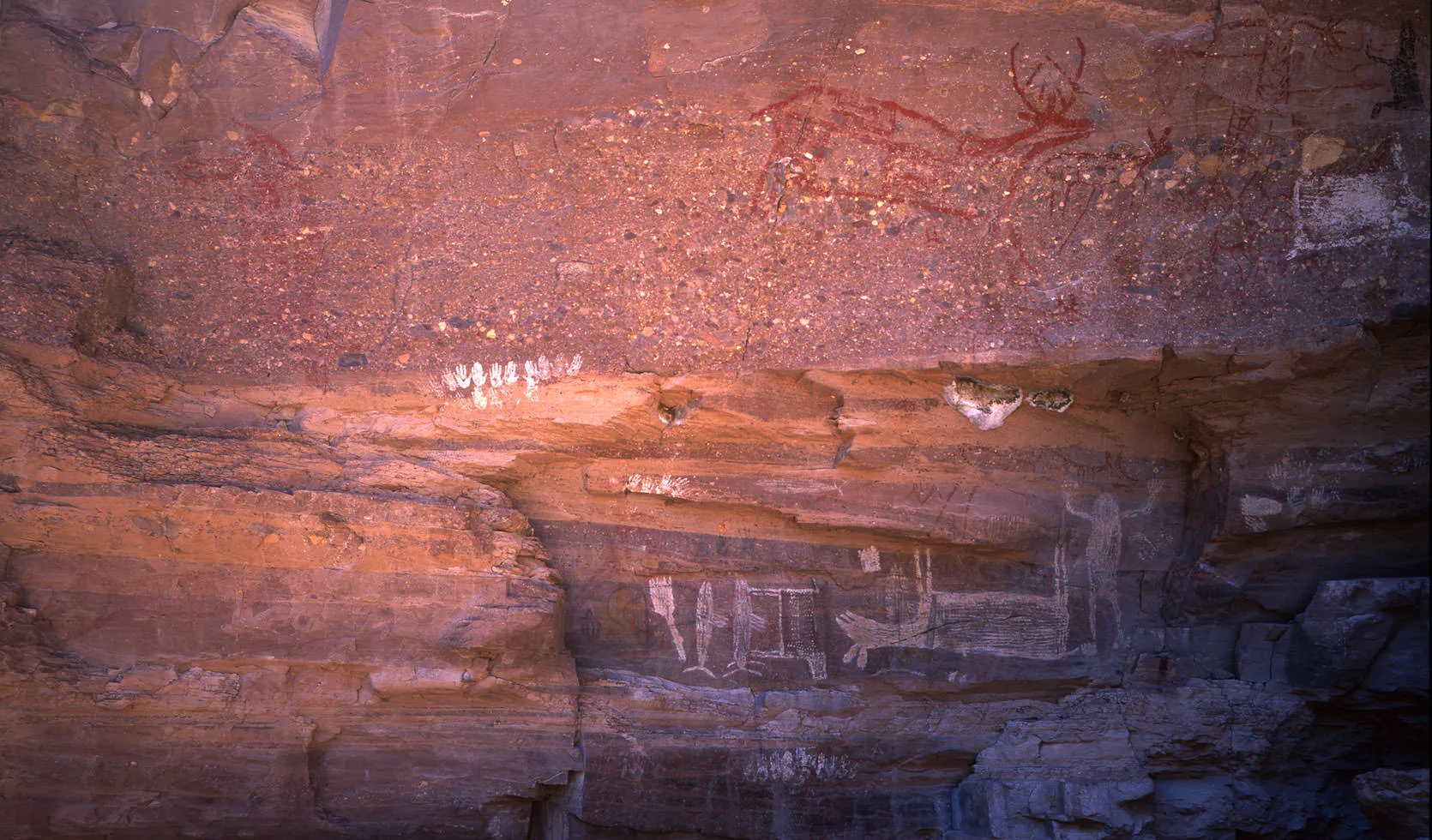 Faded red pictographs, including a deer, painted on a cave wall in the Sierra de Guadalupe near Rancho La Trinidad, Baja California Sur.