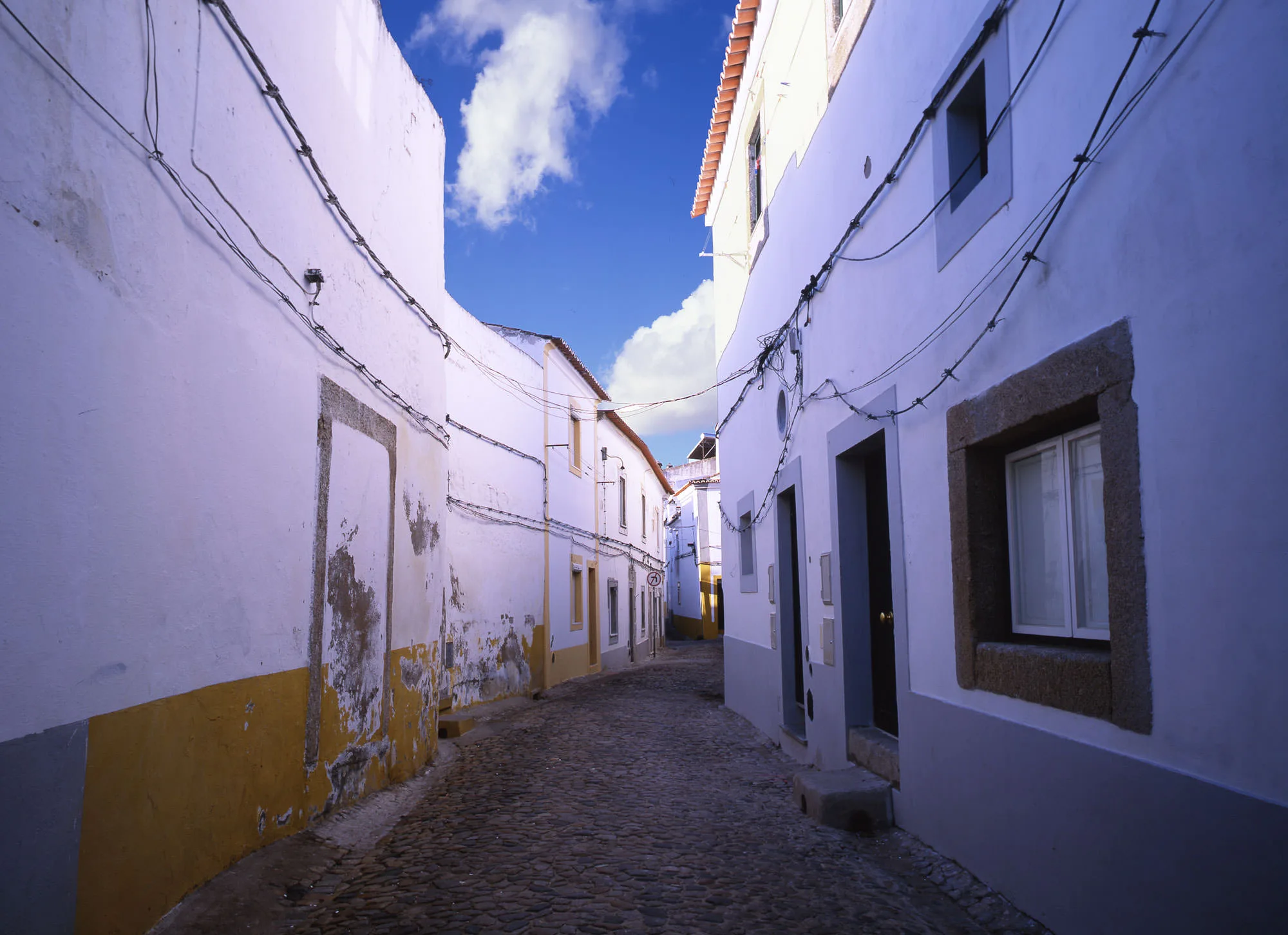 Evora, Portugal in the morning, with bright yellow and blue trims.