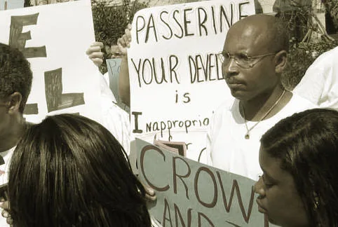 Glenn Laing at a protest against the Passerine development, holding a sign reading it is 'inappropriate', Great Guana Cay