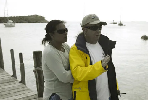 A man in a yellow rain jacket and a woman on a dock at Great Guana Cay