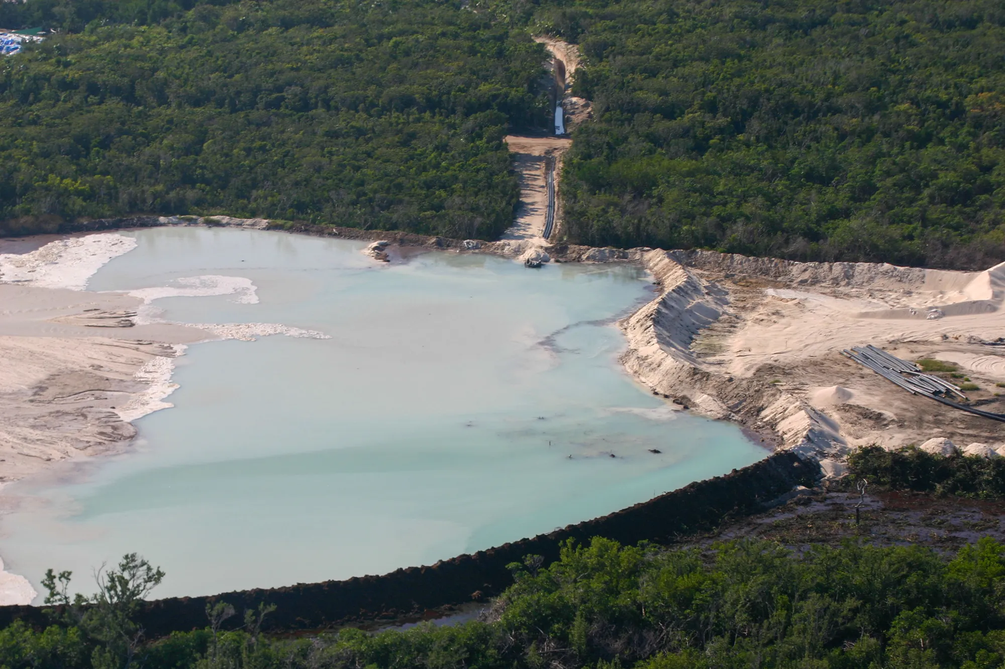 Aerial view of the Bakers Bay marina basin being cut out of Great Guana Cay's coppice forest