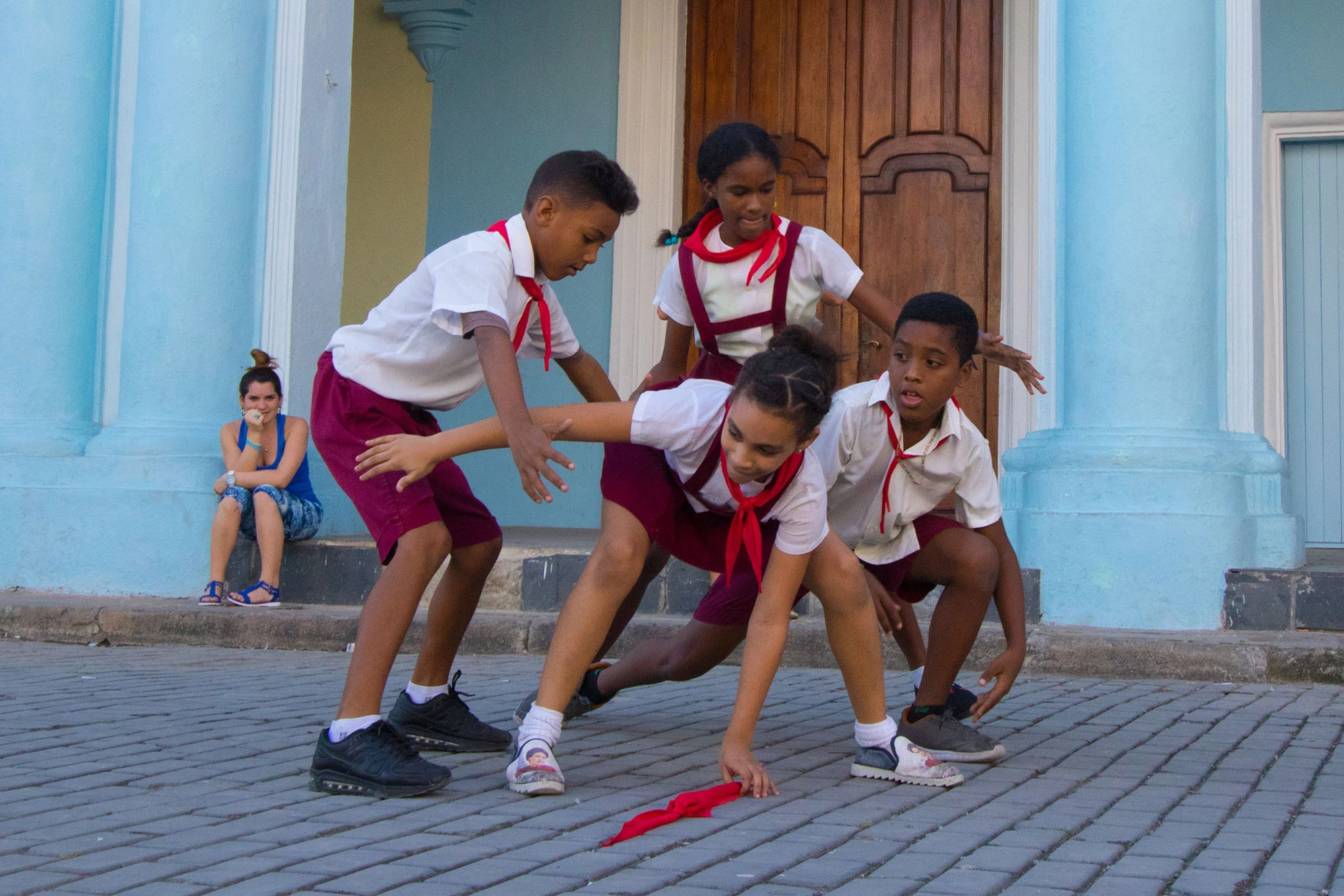Schoolchildren play the game of Pañoleta in Havana, Cuba