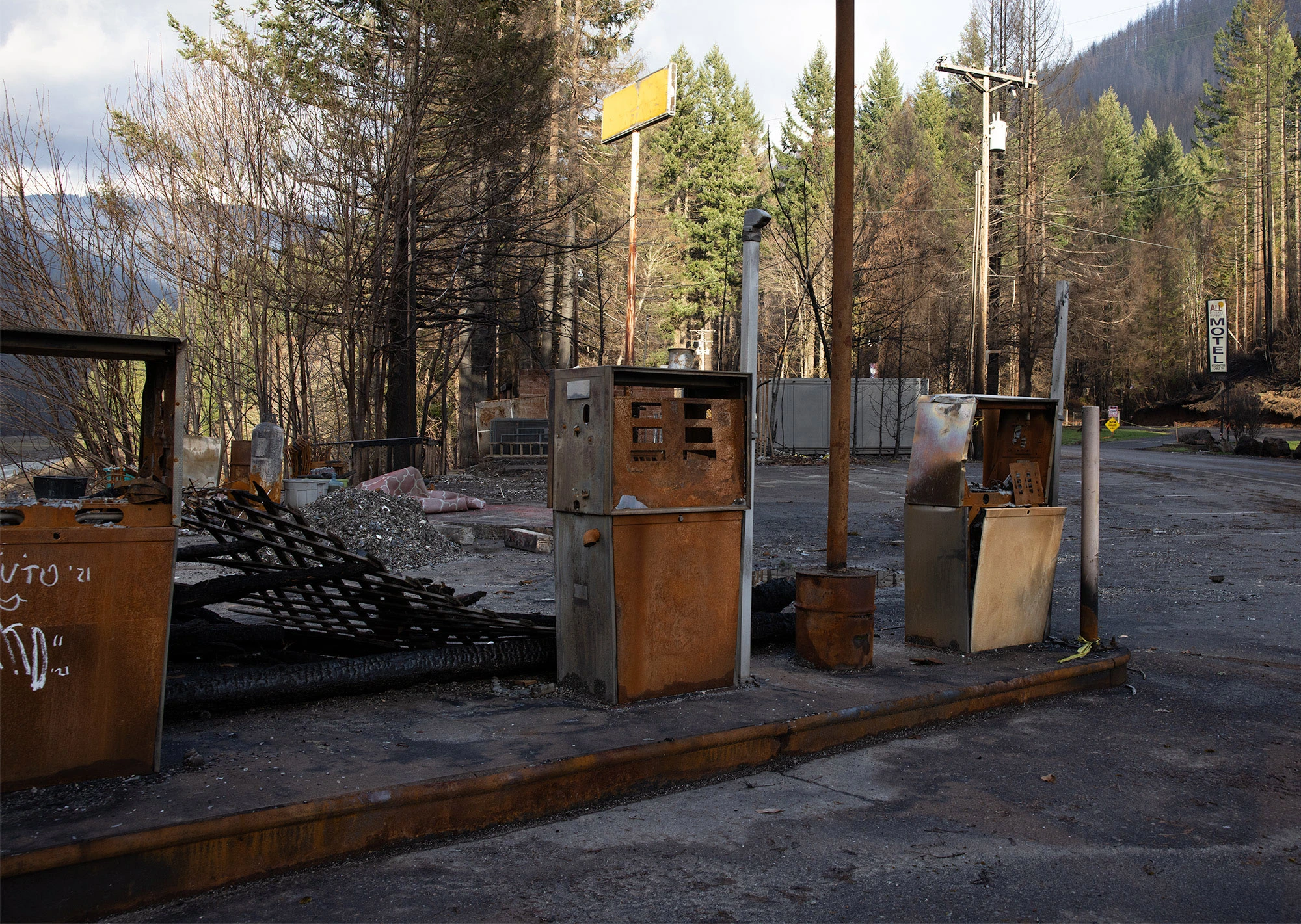 Burned gas pumps and destroyed structures in Detroit, Oregon after the September 2020 Santiam Canyon wildfires, showing the scale of devastation when extreme heat, drought, and wind drive fires beyond control.