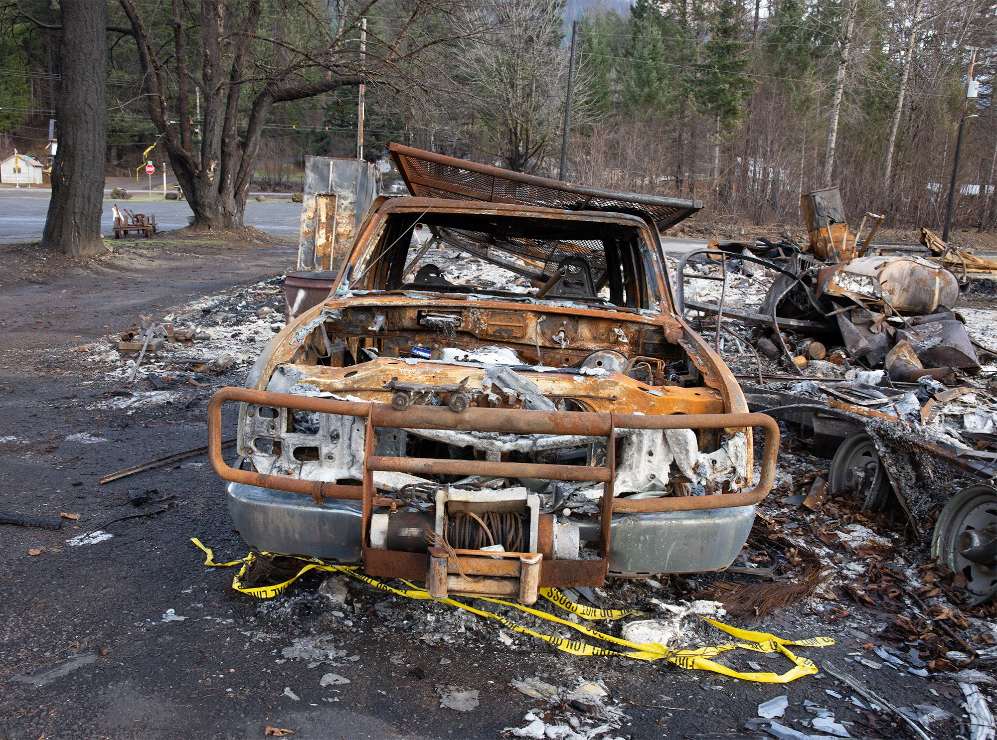 Burned vehicle in Detroit, Oregon after the September 2020 Santiam Canyon wildfires, showing the extreme heat intensity that can destroy metal and infrastructure during climate-driven fire events.