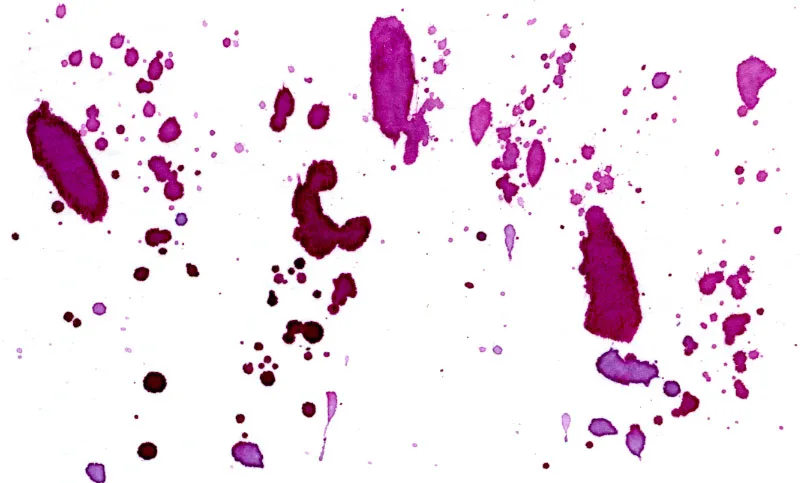 Splatters of quinacridone violet watercolor paint.