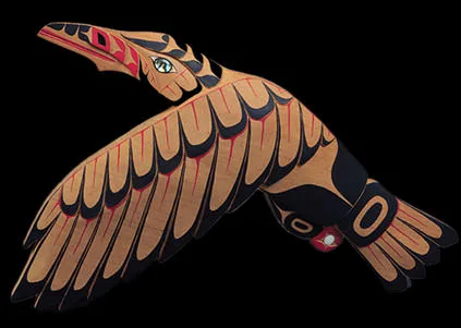 A carved and painted Northwest Coast wooden bird sculpture in traditional red-and-black formline style