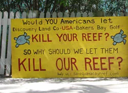 Locals at Guana Cay paint signs. This one says: Would YOU let Discover Land CO - USA - Bakers Bay Golf Kill Your Reef?
