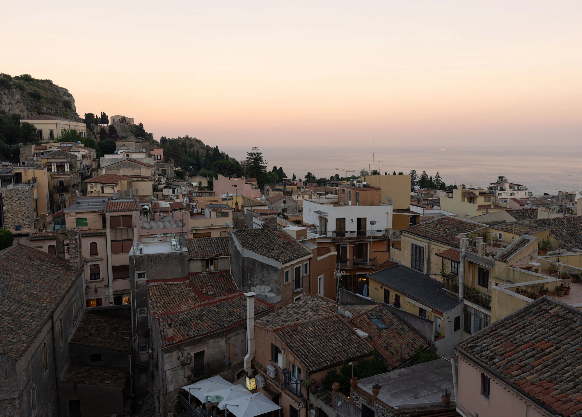 Sunset over Taormina and the Sicilian coast.