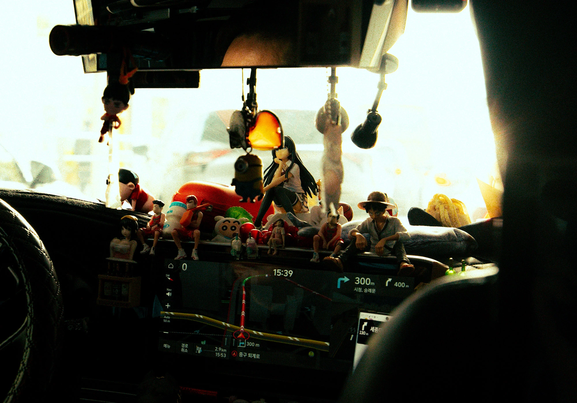 A taxi in Seoul with dashboard Anime figurines.