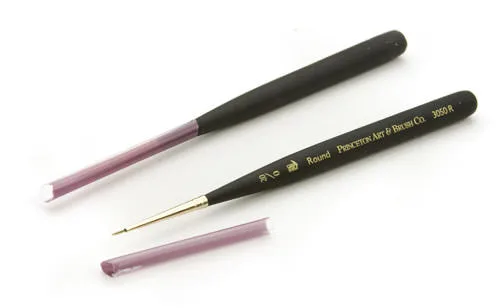Two Princeton round travel brushes with their protective caps, on white